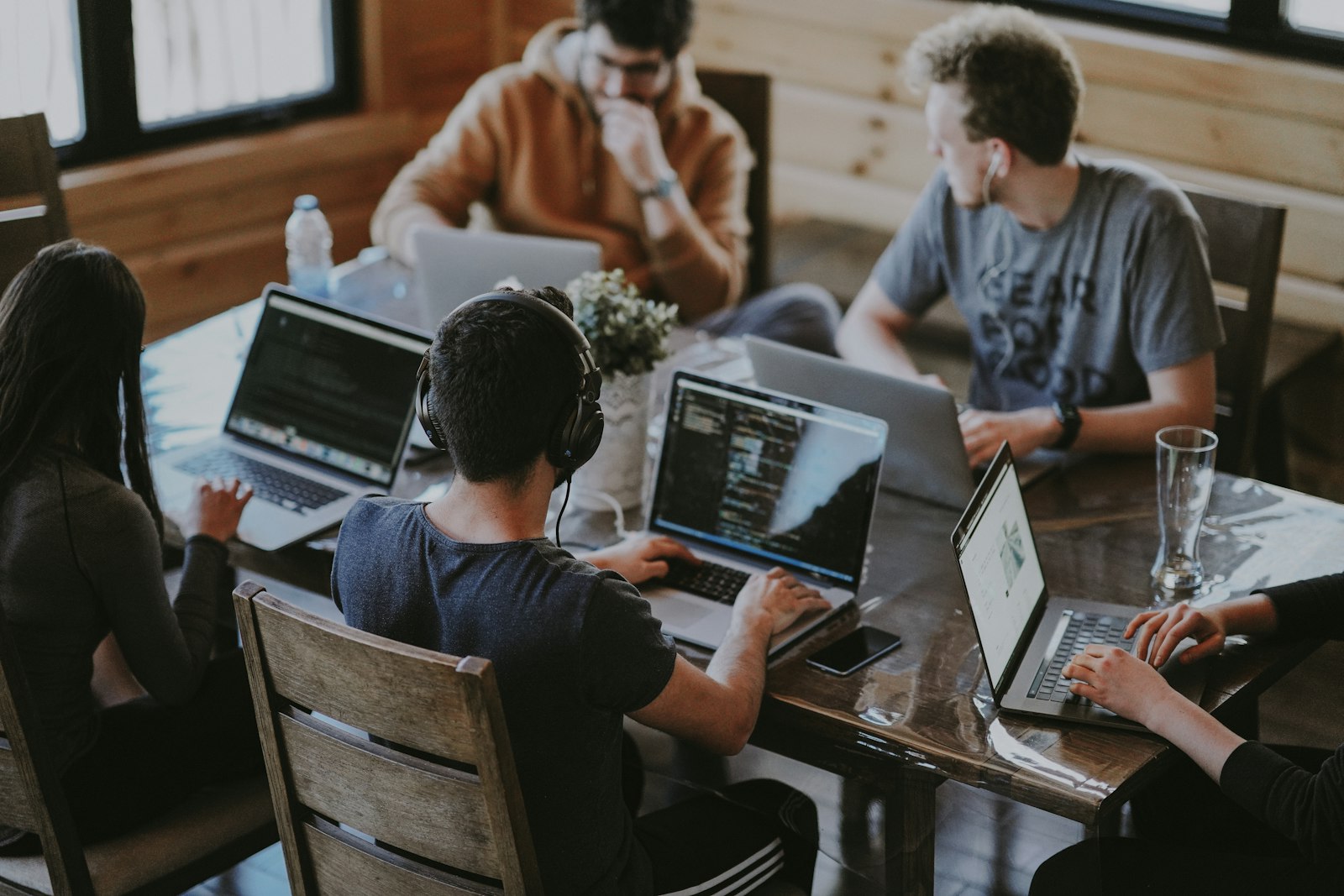 Team collaborating around a laptop